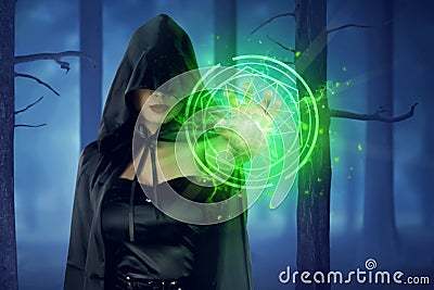 Asian witch woman with cloak showing green pentagram Stock Photo