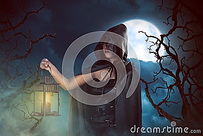 Asian witch woman holding lantern Stock Photo
