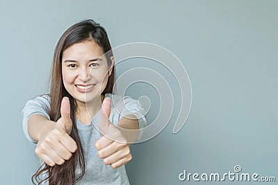 Closeup asian woman with admire motion with smile face on blurred cement wall textured background with copy space Stock Photo