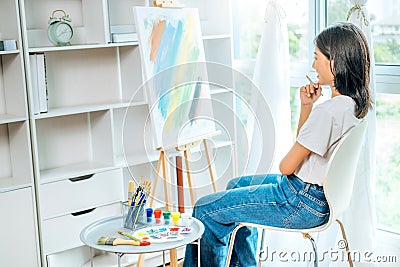 Asian Woman Artist Work and painting in the art studio at home Stock Photo