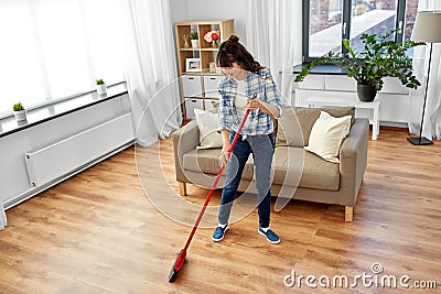 Asian woman with broom sweeping floor and cleaning Stock Photo