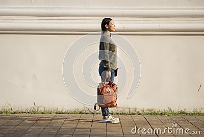 Asian woman carrying a bag Stock Photo