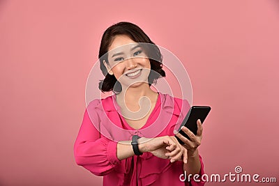 Asian woman checking time on her wristwatch, Time manage for working process. Stock Photo