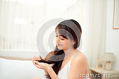 Asian woman combing her hair with anxiety Stock Photo
