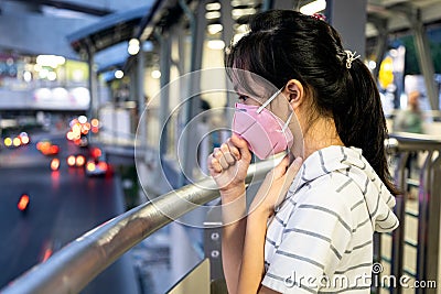 Asian woman with cough,sore throat,symptoms of fever infection the Coronavirus,outbreak of Covid-19,child girl wearing N95 face Stock Photo