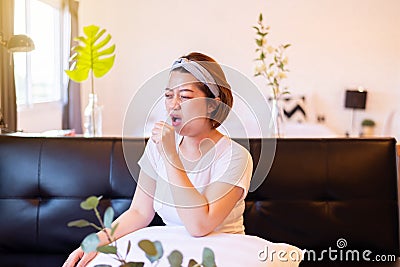 Asian woman coughing with sore throat,Women suffering with cough a lot at home Stock Photo