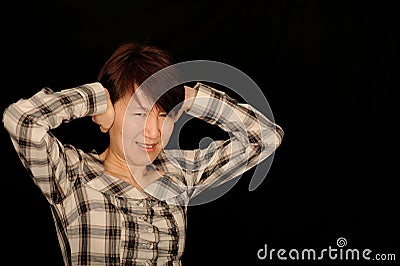 Asian woman covering ears Stock Photo