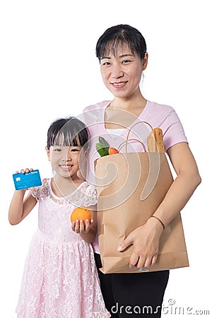 Asian Woman and daughter buying groceries with credit card Stock Photo