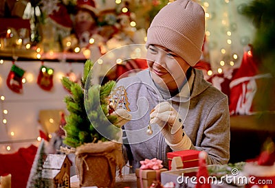Asian woman decorate for Christmas alone at home. Family celebrate and Happy new year Stock Photo