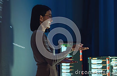 asian woman developer presentation about coding software data with devops team at night in office Stock Photo