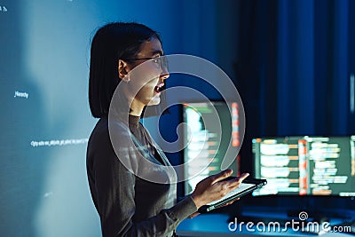 asian woman developer presentation about coding software data with devops team at night in office Stock Photo