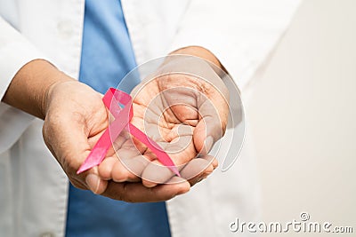Asian woman doctor with purple ribbon, sign of Alzheimer disease day, Pancreatic cancer, Epilepsy, Lupus Stock Photo