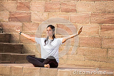 Asian Woman doing outdoor yoga meditation exercise, mental peace Fitness and health concept Editorial Stock Photo