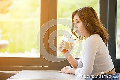 Asian woman drinking cold coffee Stock Photo