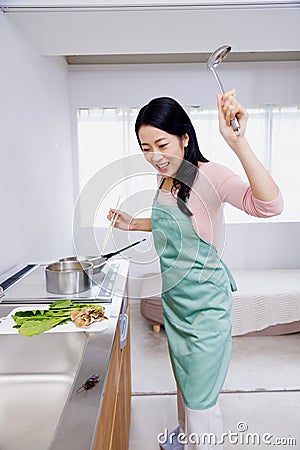 encountering a cockroach while cooking in the kitchen Stock Photo