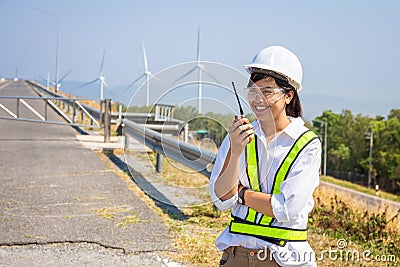 Asian woman engineers are using walkie-talkies outdoors on site power plant energy Stock Photo