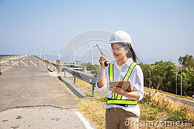 Asian woman engineers are using walkie-talkies and tablet outdoors on site power plant energy Stock Photo