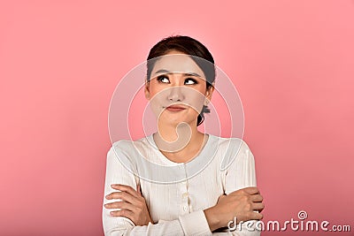 Asian woman feeling upset and frustrated, Girl rolling eyes with boredom and annoy about gossip Stock Photo