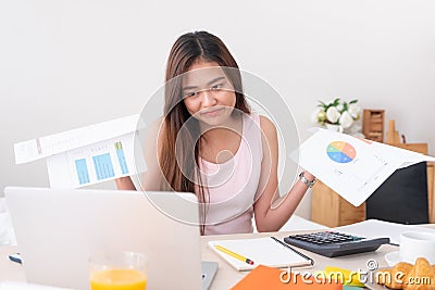 Asian woman freelancer upset with work problem with laptop on mess table.work at home concept.stress working Stock Photo