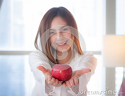 Asian woman give red apple Stock Photo