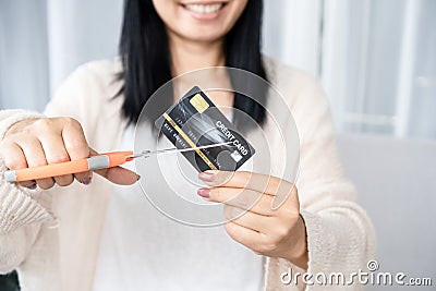 Asian woman hand holding scissors cutting credit card financial, debt freedom concept Stock Photo