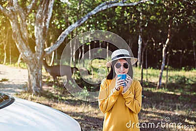 Asian woman hands drinking a glass of hot coffee in the morning at outdoor Stock Photo