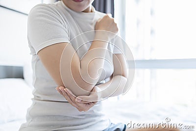 Asian woman have elbow pain,Cubital Tunnel Syndrome,Tennis elbow,inflammation of tendon or ligament injury,overuse of arm muscles, Stock Photo
