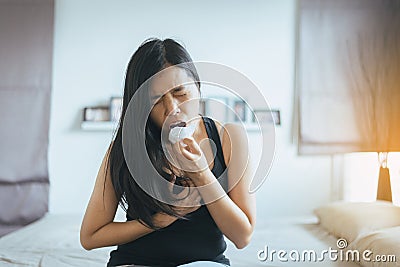 Asian woman have a morning sickness,Pregnant female nausea after wake up in bedroom Stock Photo