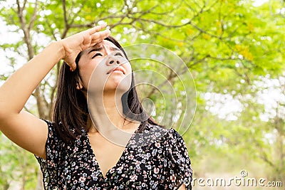 Asian woman having problem sunburn ,melasma, freckles on skin, hand cover her face to protect UV sunlight Stock Photo