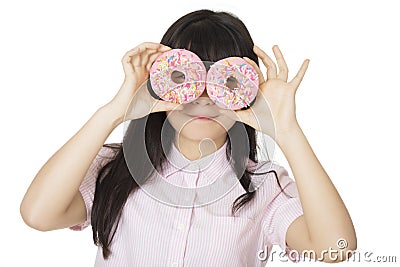 Asian woman having some fun with delicious strawberry frosted donuts Stock Photo