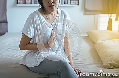 Asian woman having or symptomatic reflux acids Stock Photo