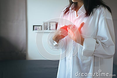 Asian woman having or symptomatic reflux acids,Gastroesophageal reflux disease,Because the esophageal sphincter that separates the Stock Photo