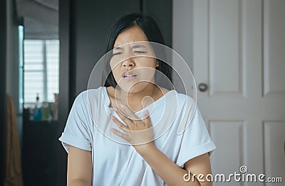 Asian woman having or symptomatic reflux acids Stock Photo