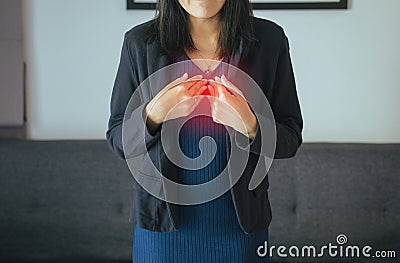 Asian woman having or symptomatic reflux acids,Gastroesophageal reflux disease,Because the esophageal sphincter that separates the Stock Photo