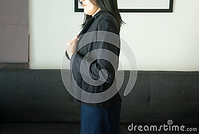 Asian woman having or symptomatic reflux acids,Gastroesophageal reflux disease,Because the esophageal sphincter that separates the Stock Photo