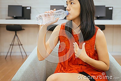 Asian woman having or symptomatic reflux acids,Gastroesophageal reflux disease,Because the esophageal sphincter that separates the Stock Photo