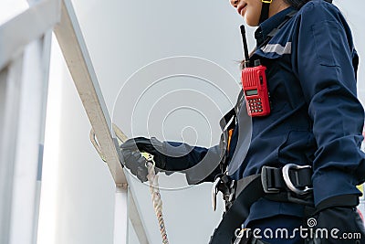 Asian woman Inspection engineer preparing and progress check of a wind turbine with safety in wind farm in Thailand Stock Photo