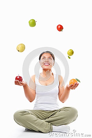 Asian woman juggling fruits Stock Photo