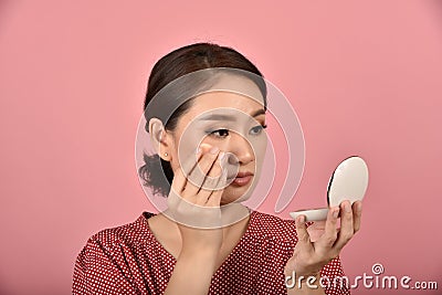 Asian woman looking at her facial problem in the mirror, Female feeling annoy about her reflection appearance show the aging skin. Stock Photo