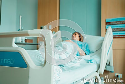 Asian woman lying sick in hospital Stock Photo