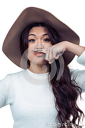 Asian woman with mustache on finger posing for the camera Stock Photo