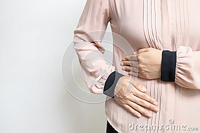 Asian woman patient with abdominal pain on right side belly,painful in abdomen,irritable bowel disease,lady girl holds under the Stock Photo