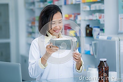 Pharmacist packs medicines in plastic Stock Photo