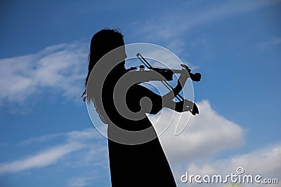 Asian Woman playing violin instrument in Silhouette shape with s Stock Photo