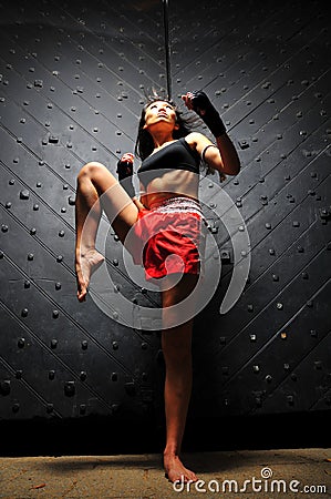 Asian Woman Practising Muay Thai Boxing Stock Photo