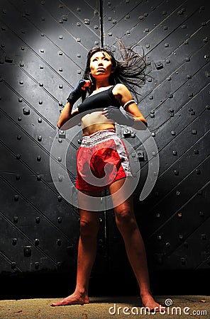 Asian Woman Practising Muay Thai Boxing Stock Photo