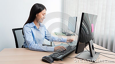Asian woman Programming working with computer and typing data code to developing program at table In Office, technology concept Stock Photo