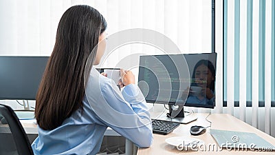 Asian woman Programming working with computer and typing data code to developing program at table In Office, technology concept Stock Photo