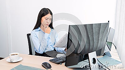 Asian woman Programming working with computer and typing data code to developing program at table In Office, technology concept Stock Photo