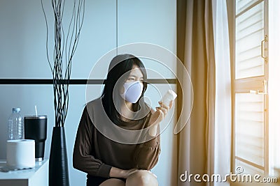 Asian woman reading medicine label and prescription medications,Health care and people concept Stock Photo